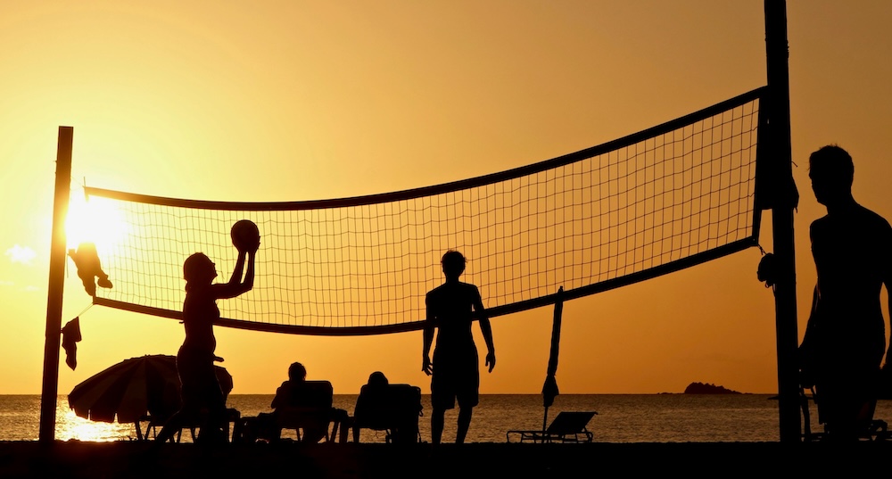 people in seaside with beach umbrella