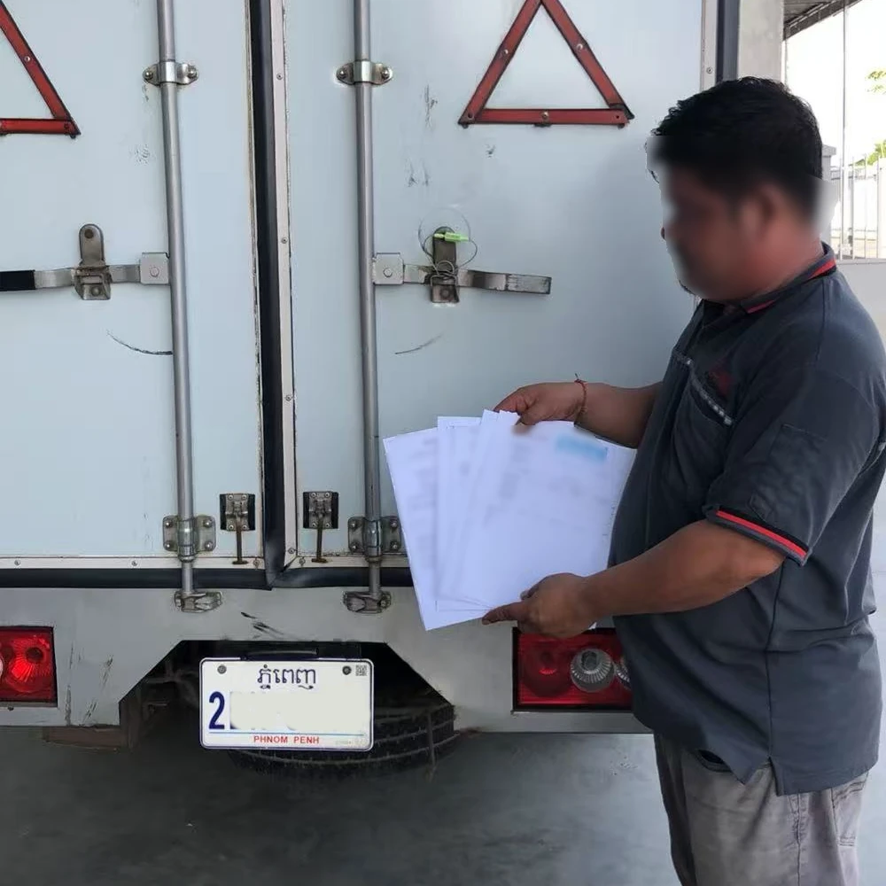 Group photo of driver and Topumbrella Cambodia logistics team after loading