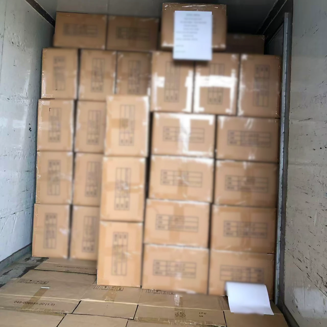 Team loading umbrella cartons into the container with pallet jack and load plan